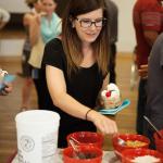 person building ice cream sundae