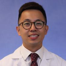 Headshot of medical student Jonathan Gan with light blue background