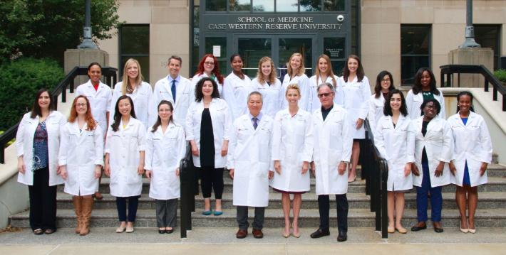 Picture of group of doctors in front of CWRU SOM.