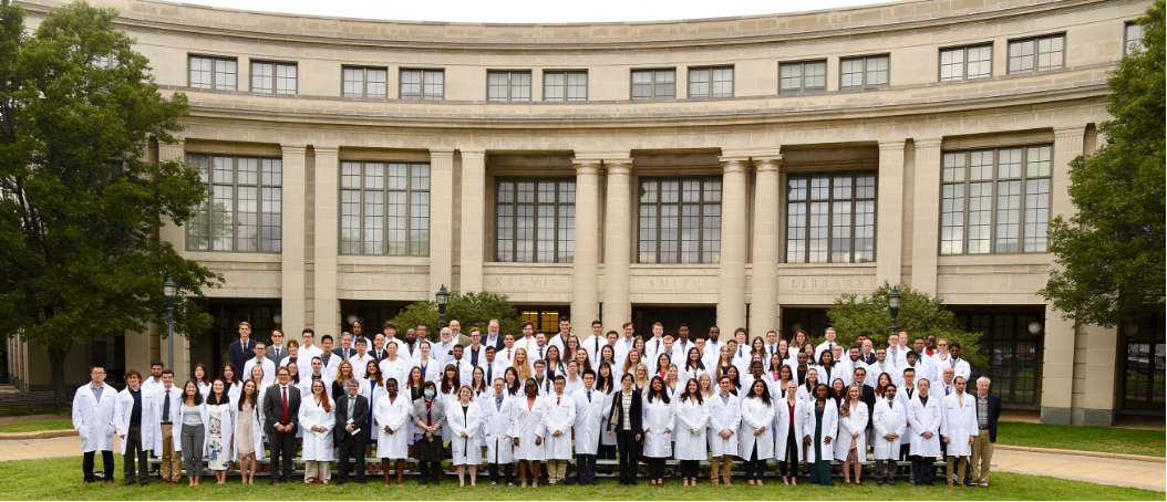 Students wearing white coats 