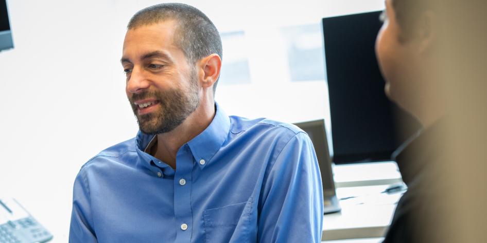 Man smiling at something off camera
