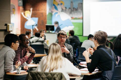 Five students at CWRU medical school sit facing each other in discussion