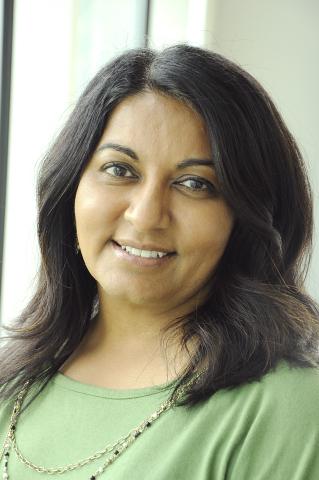 Nital Subhas wearing a green shirt against a window background