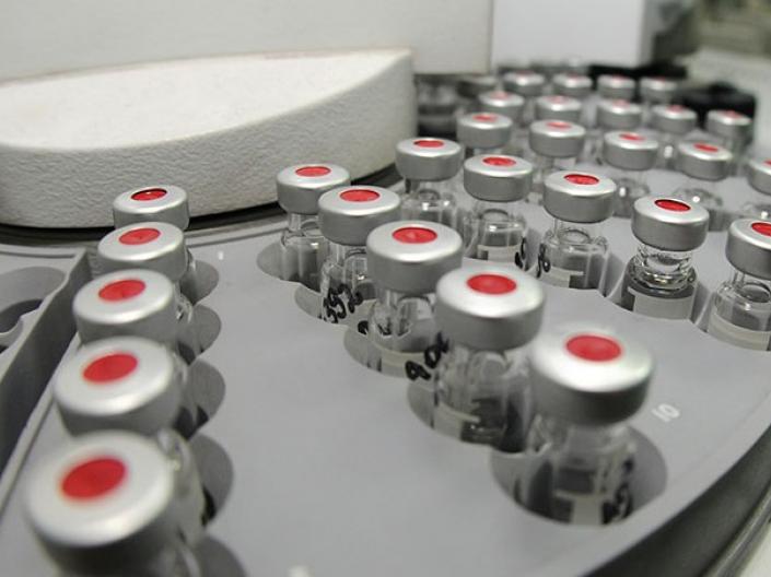 A close-up of test tube vials in a machine