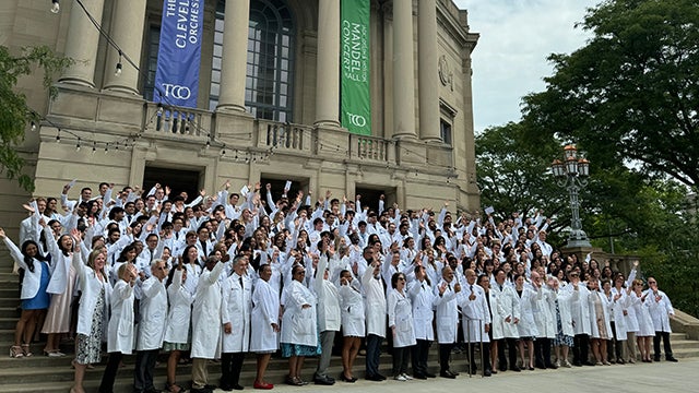 MD students in their white coats outside Severance Music Center