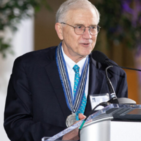 Photo of Dr. Jim Young speaking at a podium