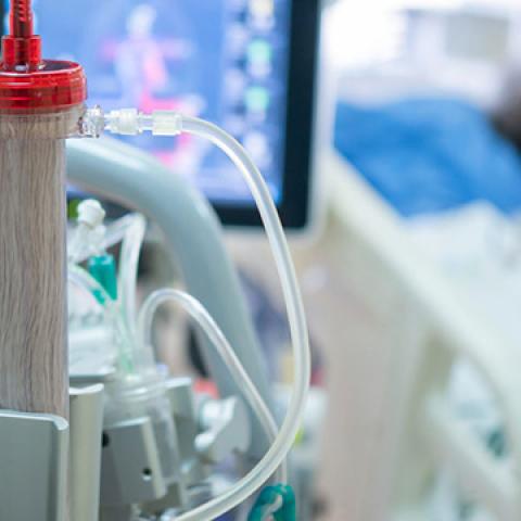 stock image of equipment used to treat kidney disease, blurred patient in background