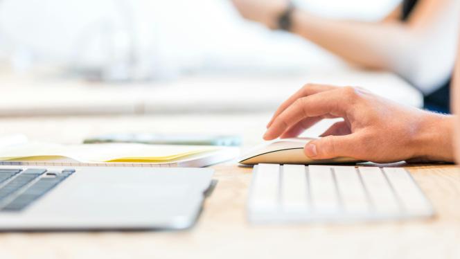 A person using a mouse and keyboard.