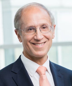 Portrait of Stan Gerson in dark suit with light colored tie