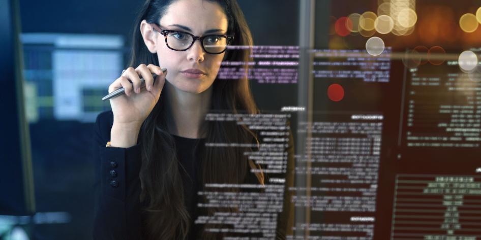 Close up of a professional woman looking at data on a virtual screen