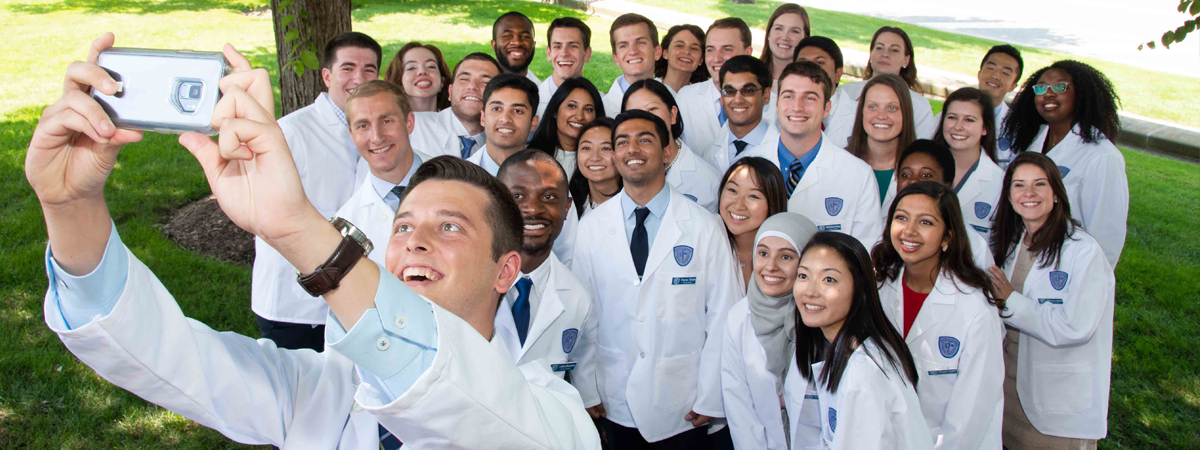 CWRU Medicine students take group selfie at the White Coat Ceremony