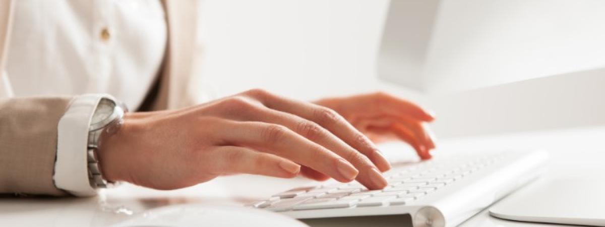 Close-up of a  woman typing on a keyboard