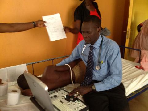Emmy Okello treating patient