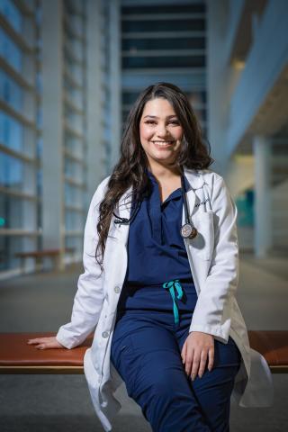 Case Western Reserve University School of Medicine student Emily Manning poses in a white coat