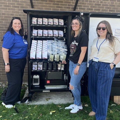 Maggie Urban-Waala and others installing a NaloxBox in Summit County