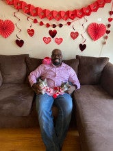 Razaq Durodoye holding his two cats 