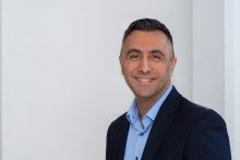 Ozan Akkus smiling at the camera.
