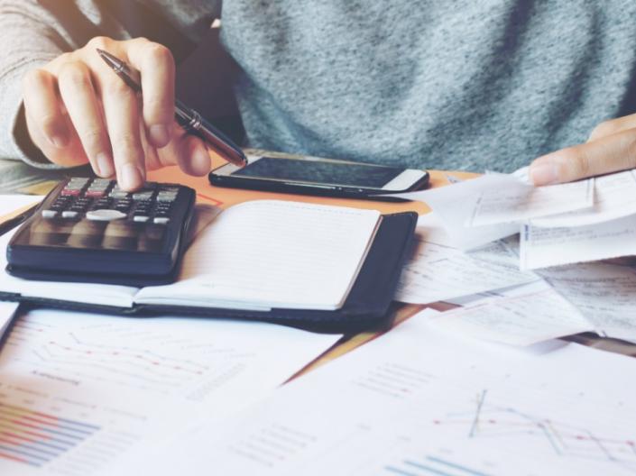 A close-up of a student working on finances