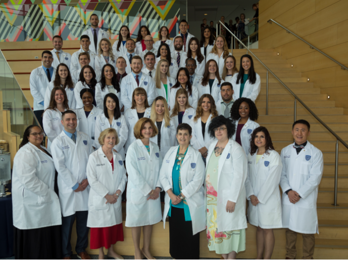 Physician Assistant members posing on the steps for a photo