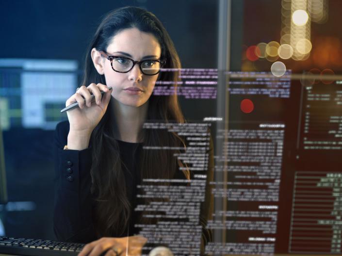 Close up of a professional woman looking at data on a virtual screen
