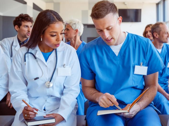 A group of medical professionals in a lecture setting.