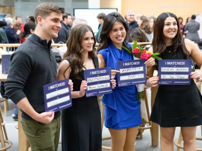 Students stand together for a photo on Match Day with their program matches.