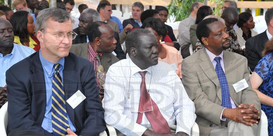 Photo of three males sitting at conference
