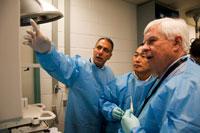 Men in a lab in their lab coats.