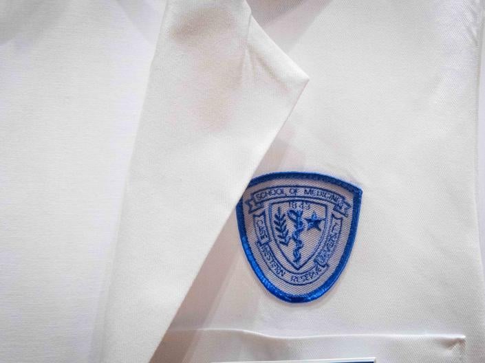 Close up image of lab coat breast with program patch in center frame