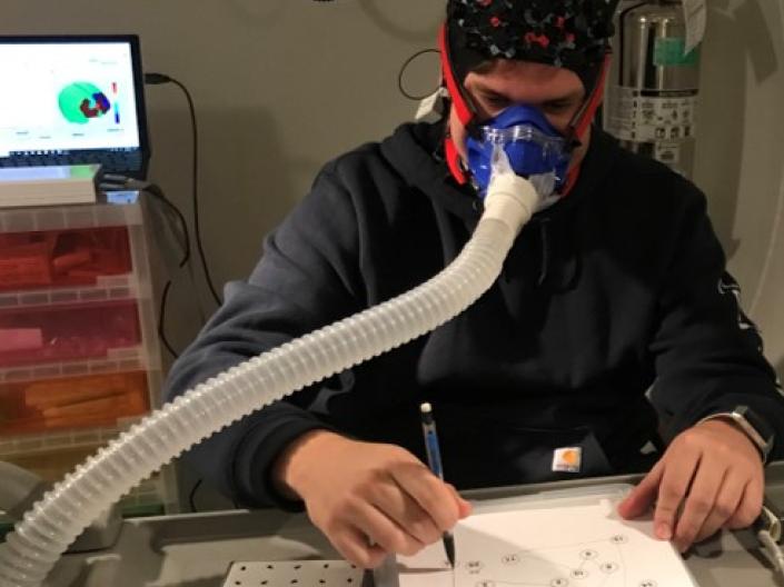 Study participant completing a pegboard assessment in the hypobaric chamber
