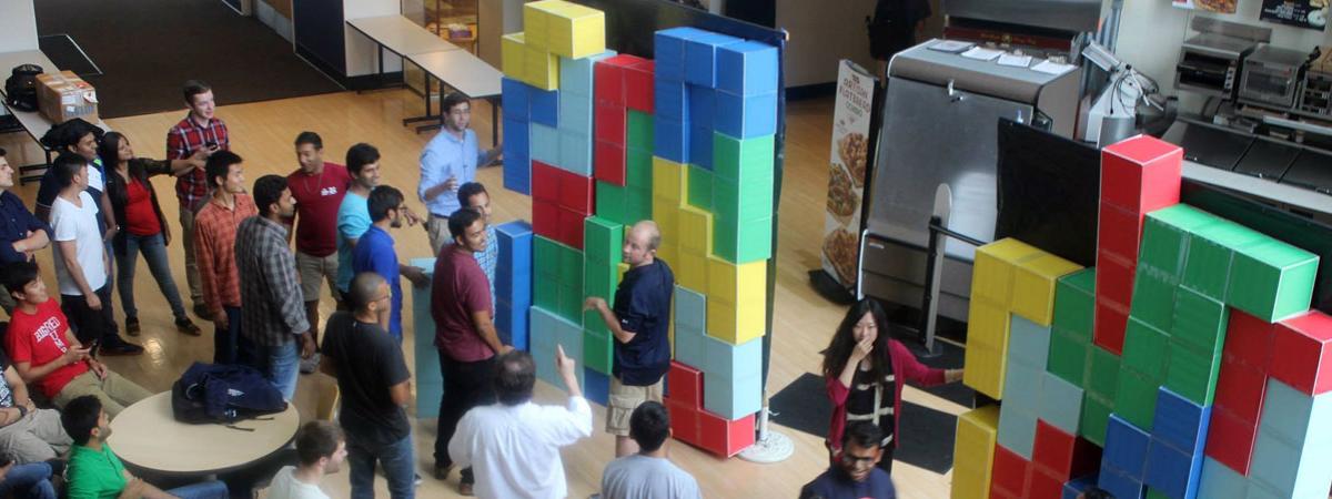 A group of students playing a life sized tetris