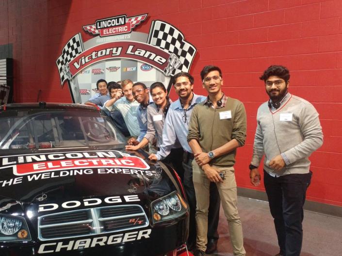 MEM students posing with a racecar at Lincoln Electric