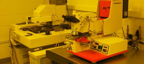A laboratory scene with a microscope and various equipment.