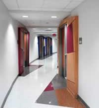 Photograph of a hallway with many doors leading to lab rooms