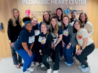 Cristin Coleman and other founding members of UH Rainbow Babies & Children’s Hospital's pediatric cardiac intensive care unit pose for a group photo.