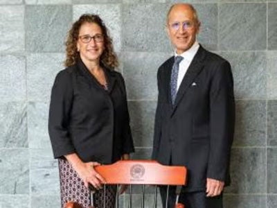 Lia Logio and Stan Gerson pictured in front of her chair