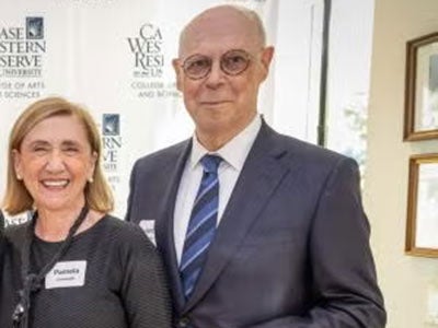 Pamela and Kent Cartwright pictured in front of a CWRU step and repeat banner