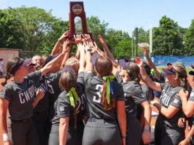 CWRU softball players lift the trophy following their victory against Coe College and sweep of the best-of-three 2024 Super Regional