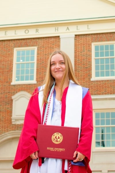 Sophie Kwiatkowski standing in front of a building