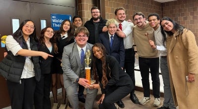 Group of students posing with a trophy