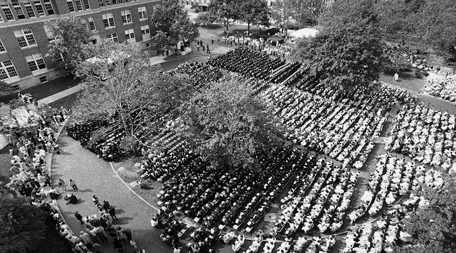 Black and white photo taken from above of people gathered on a quad on CWRU's campus for a commencement event