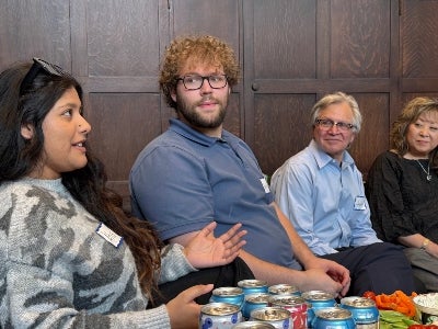 Four people seated next to one another in discussion