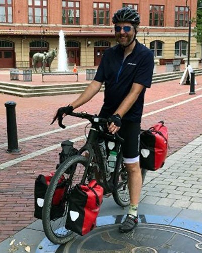 Rob Kollin on a bike on a brick street in Cumberland, Maryland.