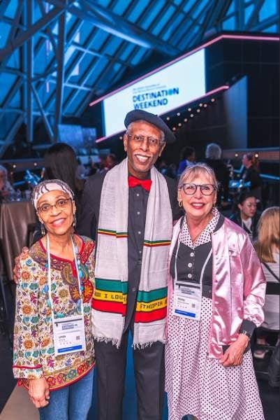 Image of three people smiling at the Rock Hall 