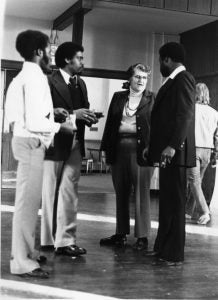 Patricia Kilpatrick talking with three men