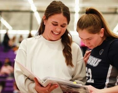 Photo of Brooke Beecher with student basketball player.