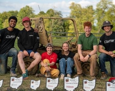 Photo of Samantha Hepp with CWRU BAJA SAE team drivers at the 2023 BAJA SAE Ohio Competition.