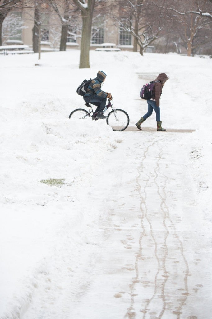 CWRU students biking and walking to class in winter