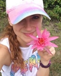 Photo of Deanna Duffy holding a flower.