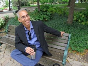 Deepak Sarma on a bench at CWRU